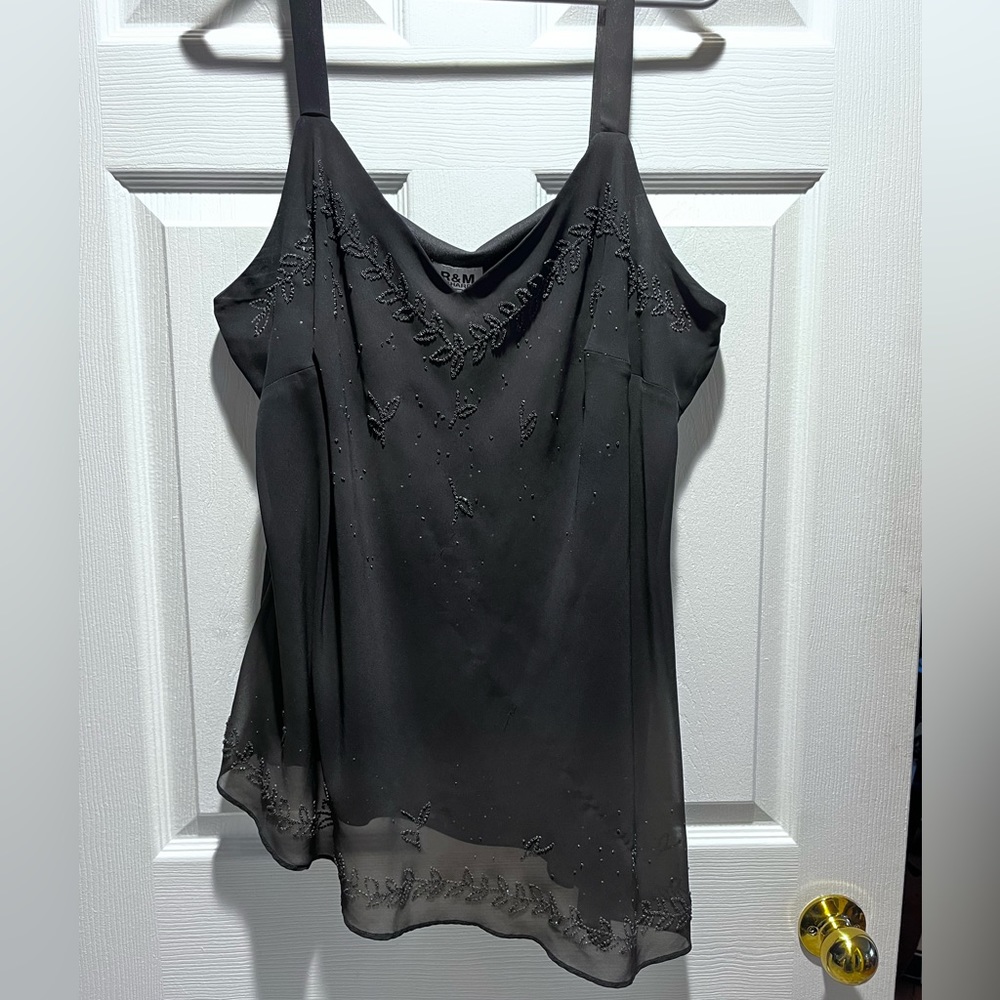 Black asymmetrical top with pretty sparkly detail. Sz 20. Good condition.